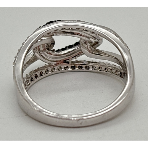 1119 - A rhodium plated cocktail ring set with Swarovski crystals. A 3 link design with central link set wi... 