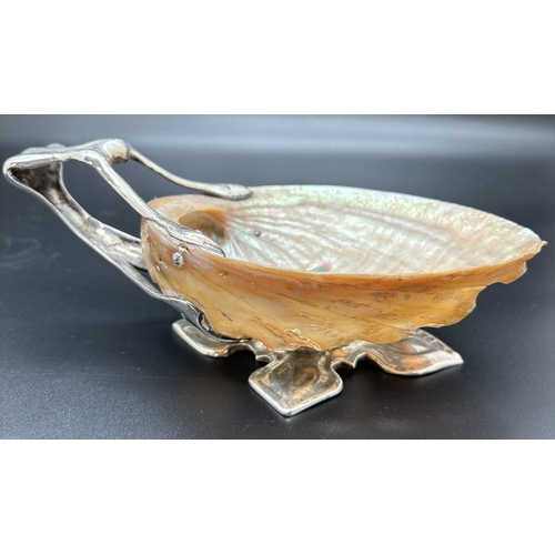 1201 - An Art Nouveau/Arts & Crafts silver and shell dish with foliate style quatrefoil foot and open work ... 