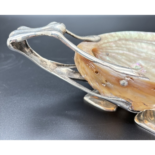 1201 - An Art Nouveau/Arts & Crafts silver and shell dish with foliate style quatrefoil foot and open work ... 