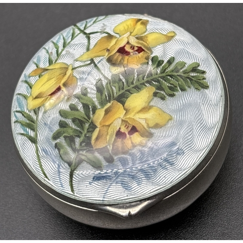 1203 - An Edwardian silver circular shaped trinket box with guilloche lid of floral design. Fully hallmarke... 