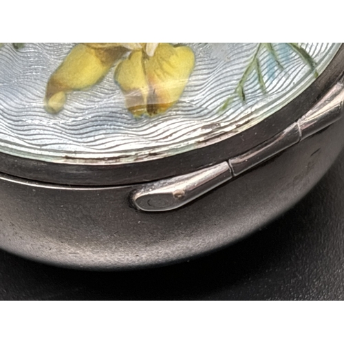 1203 - An Edwardian silver circular shaped trinket box with guilloche lid of floral design. Fully hallmarke... 