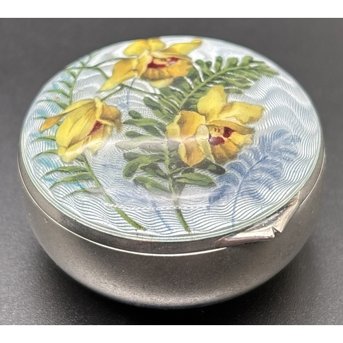 1203 - An Edwardian silver circular shaped trinket box with guilloche lid of floral design. Fully hallmarke... 