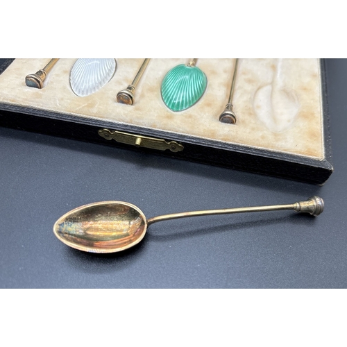 1206 - A boxed set of Art Deco silver gilt and coloured enamel seal top demitasse spoons. Each fully hallma... 