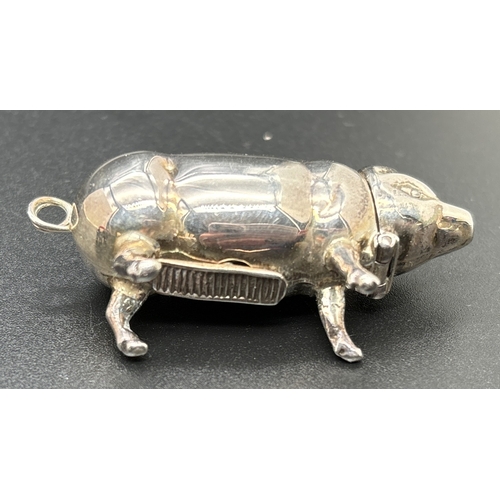 1214 - A modern silver vesta modelled as a pig, together with a small silver pig pin cushion. Both stamped ... 