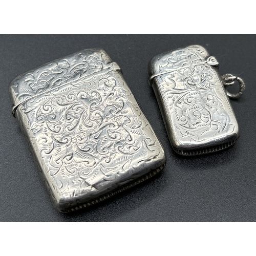 1219 - 2 Victorian silver vesta cases with engraved scroll & foliate design & empty shield shaped cartouche... 