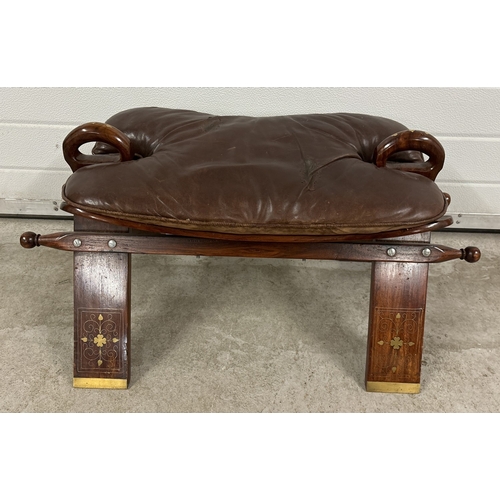 1413 - A vintage Anglo-Indian camel stool with brass inlay detail. Wear to brown leather cushion on one sid... 