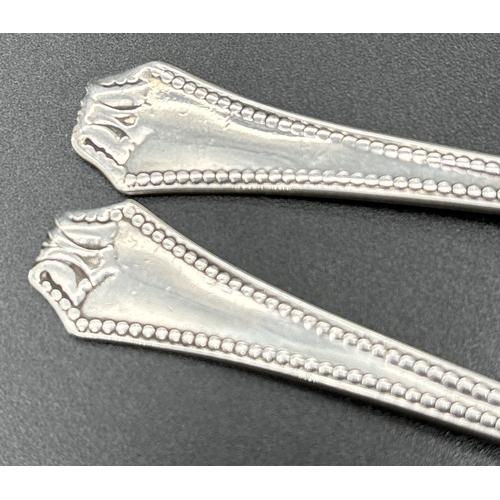 1223 - A set of 4 Art Deco silver tea spoons with beaded design to handles. Each fully hallmarked to unders... 