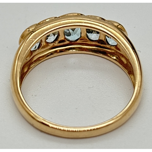 7 - A 9ct gold dress ring with 5 oval cut bezel set blue topaz stones. Central stone approx. 6 x 4mm wit... 