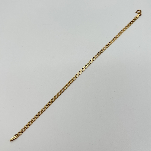 11 - A 9ct gold 7 inch double curb chain bracelet with spring ring  clasp. Gold marks to fixing and clasp... 