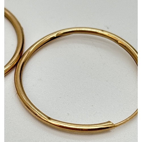 13 - 3 pairs of yellow gold hoop earrings, one with engraved pattern to one side. Largest pair approx. 3c... 