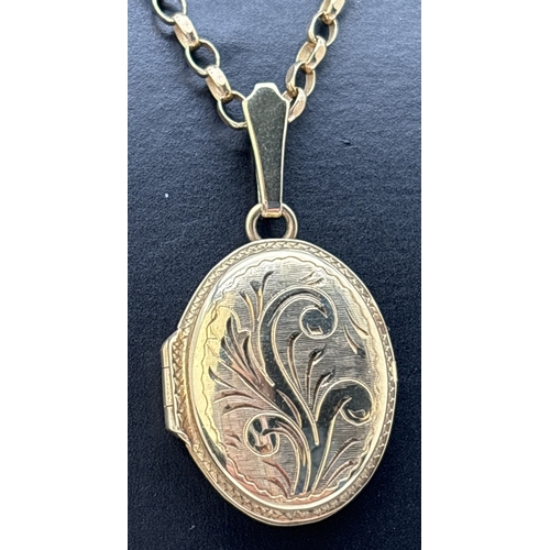 14 - A 9ct gold oval shaped locket with floral engraved design to front, on an 18