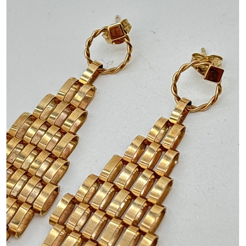 36 - A pair of 9ct gold drop style earrings. Diamond shaped drops made from gold links, suspended from a ... 