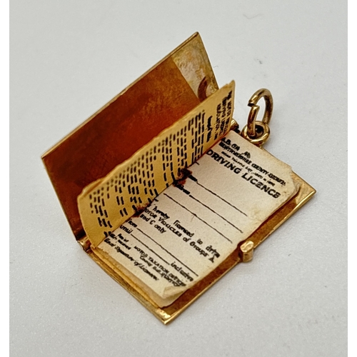 43 - A 9ct yellow gold Driving Licence charm/pendant. Charm opens to reveal paper pages. Gold marks to re... 