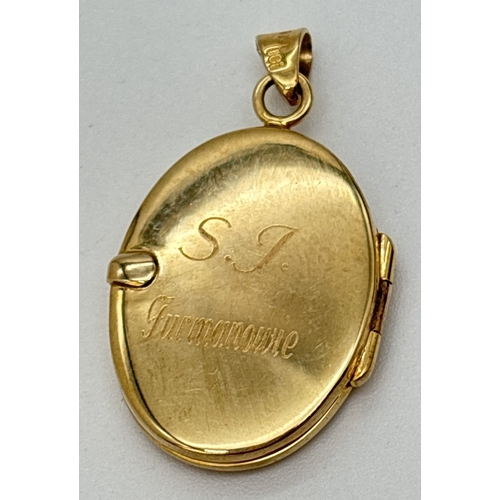 49 - A 9ct gold oval shaped locket with floral engraved decoration to front. Engraved to back 'S.J Furman... 