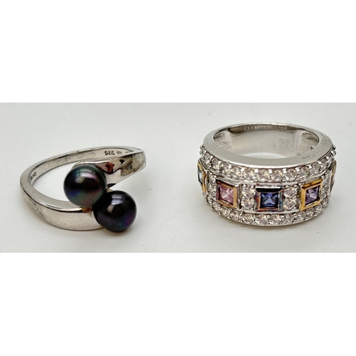 55 - 2 boxed silver rings. A crossover design ring set with 2 peacock pearls, together with a silver band... 