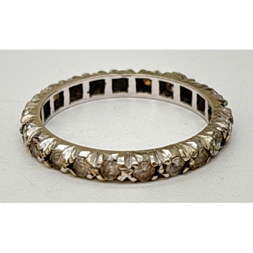 66 - A vintage 9ct white gold full eternity ring set with white spinel stones. Gold marks inside band. Si... 