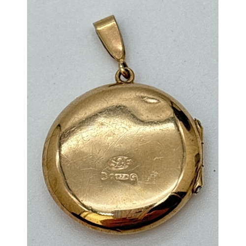 68 - A small circular 9ct gold locket with half floral engraved decoration to front. Hallmarked to back. ... 