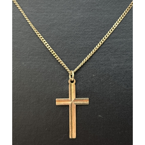 69 - A 9ct gold cross pendant with ridged detail, on an 18