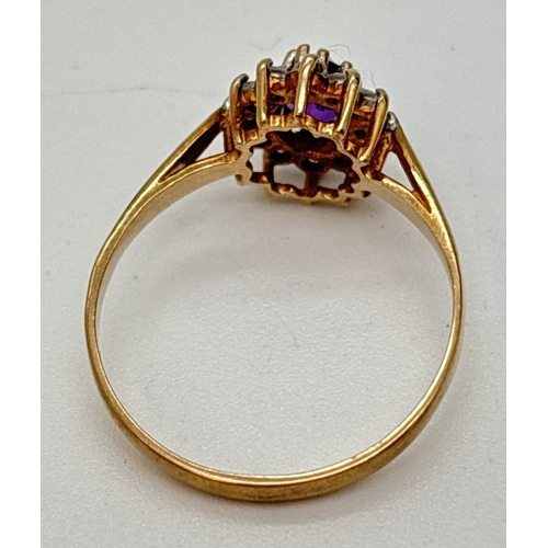 74 - A 9ct gold amethyst and Cubic Zirconia cluster style dress ring. A central oval cut amethyst surroun... 