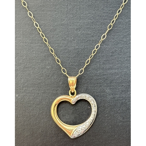 79 - A 9ct white and yellow gold open heart pendant on an 18