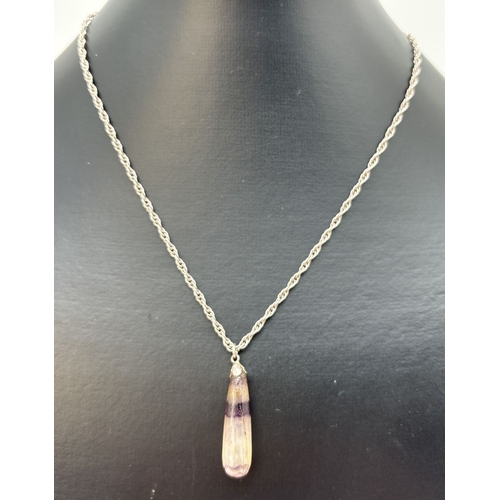 91 - A Blue John teardrop shaped pendant, on a 22