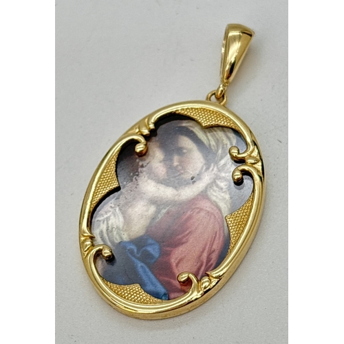  A 14ct gold oval shaped pendant with decorative mount containing a small print of the Madonna and ch... 