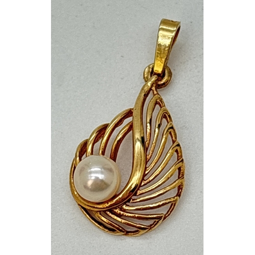 100 - A 9ct gold teardrop style pendant with openwork detail and set with single pearl. Gold mark to back ... 