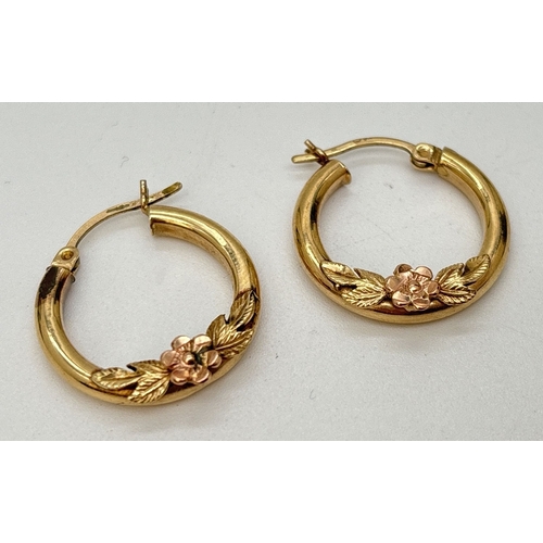 102 - A pair of 9ct gold hoop earrings with floral spray decoration. Marked 9K on posts. Approx. 2cm diame... 