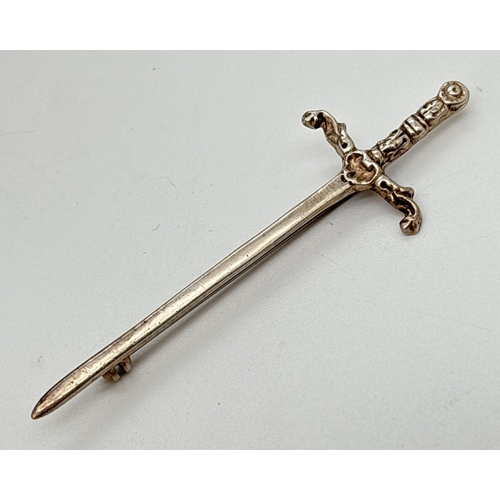 105 - A Scottish silver kilt pin/brooch in the shape of a sword. Floral work to handle of sword. Hallmarke... 