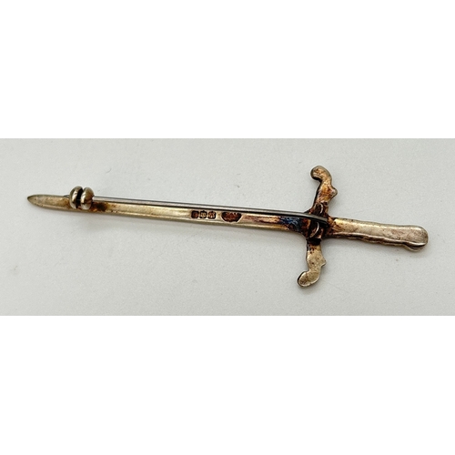 105 - A Scottish silver kilt pin/brooch in the shape of a sword. Floral work to handle of sword. Hallmarke... 