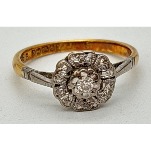 119 - A vintage 18ct gold 0.10ct diamond illusion set flower head ring. Central round cut diamond surround... 