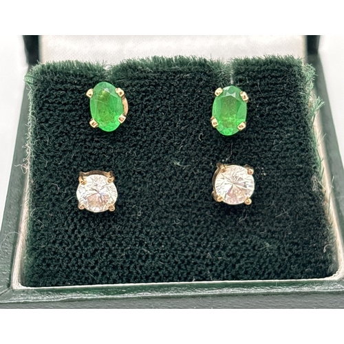 136 - 2 pairs of stone set 9ct gold stud earrings. A pair set with oval cut green stones and a pair set wi... 