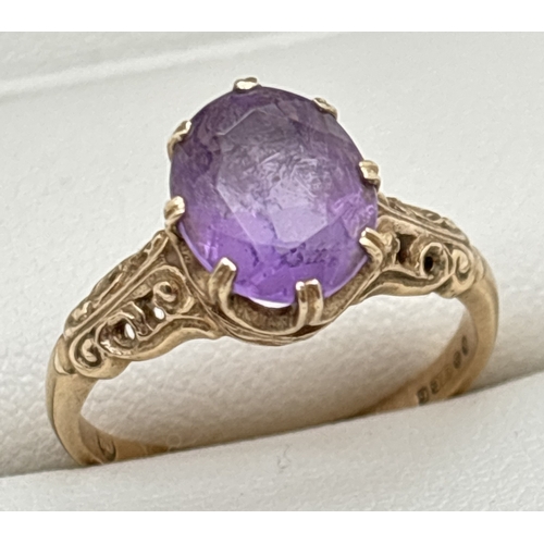 137 - A 9ct gold amethyst set dress ring with claw set stone and scroll decoration to mount and shoulders.... 