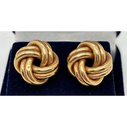 142 - A pair of 9ct gold large knot style earrings. Each earring approx. 1.5cm diameter. Hallmarks on post... 