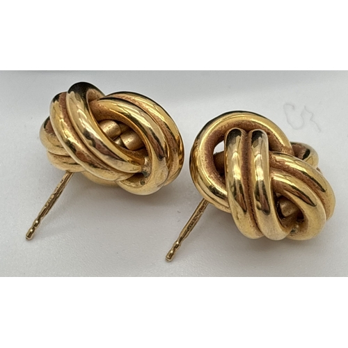 142 - A pair of 9ct gold large knot style earrings. Each earring approx. 1.5cm diameter. Hallmarks on post... 