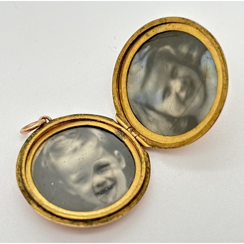 147 - A vintage 9ct gold front and back circular locket with engraving 'D.M. 1942' to front. Black and whi... 