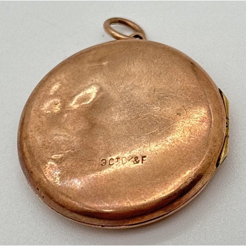 147 - A vintage 9ct gold front and back circular locket with engraving 'D.M. 1942' to front. Black and whi... 