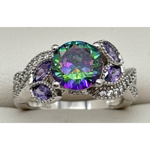 153 - A 925 silver floral design cocktail ring set with mystic topaz and clear stones. A central round cut... 