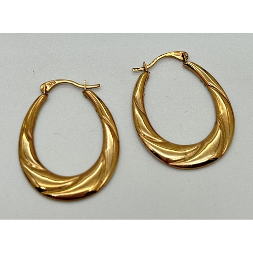 161 - A pair of 9ct gold hoop earrings set with multiple clear crystals. Stamped 375 on posts. Approx. 2.5... 