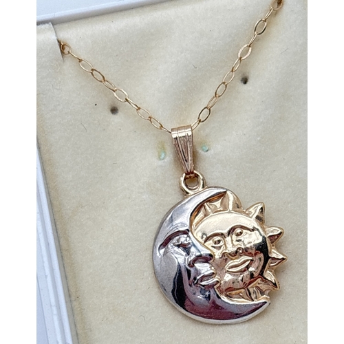  A yellow an white gold sun and moon pendant on a 18 inch fine belcher chain. Together with a pair of... 