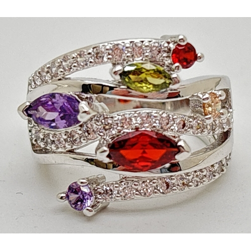 1056 - A multi band crossover design cocktail ring set with coloured & clear Swarovski crystals. In a rhodi... 