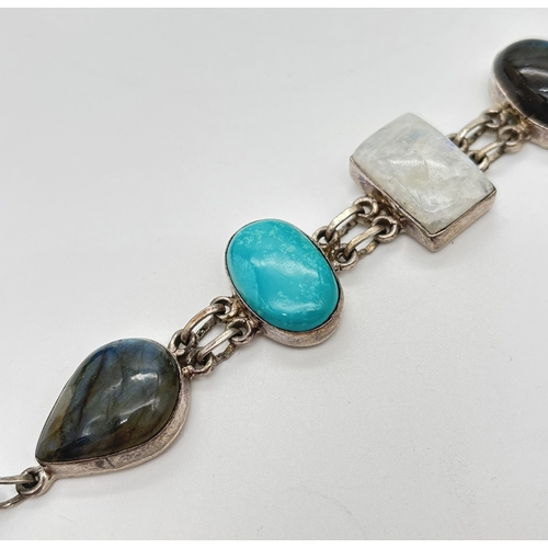 1004 - A modern design natural stone set silver bracelet with T Bar clasp. Bracelet set with 3 cabochons of... 