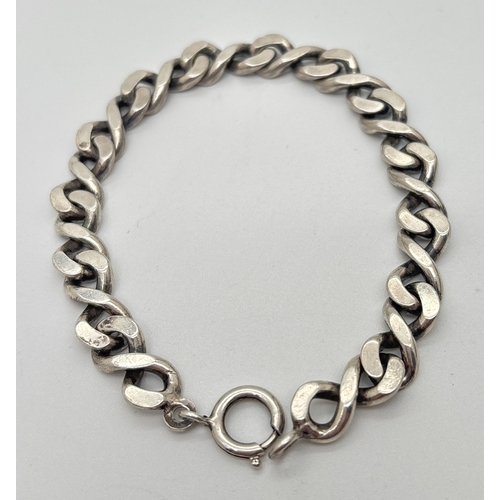 1008 - A 7.5 inch curb chain bracelet with spring ring clasp. Silver marks on fixings. Total weight approx.... 