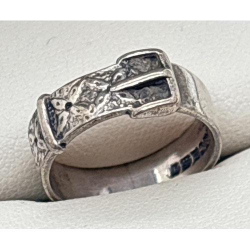 1015 - A vintage silver buckle ring with embossed floral design to top. Hallmarked inside band for Birmingh... 