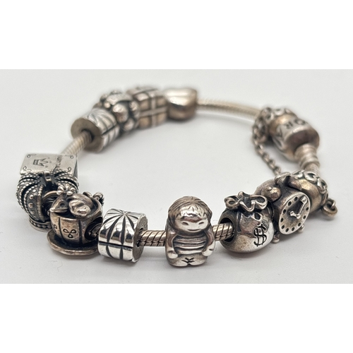 1019 - A silver charm bracelet by Pandora with 12 charm beads. Pandora and silver marks to all. Charms incl... 