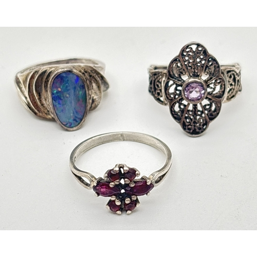 1020 - 3 stone set silver rings. A filigree design ring with central amethyst, an opal set ring with ridge ... 