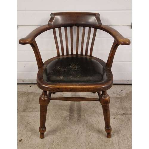 1376 - An antique dark wood smokers bow arm fireside chair with slatted back and turned legs.