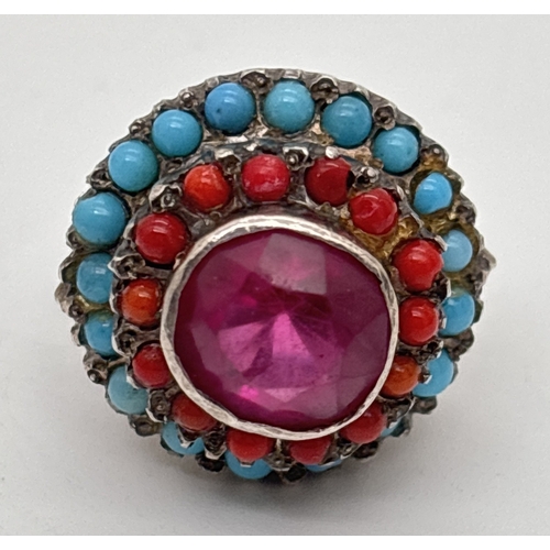 1025 - A vintage white metal ethnic style 3 tier ring set with a large central round cut ruby surrounded by... 