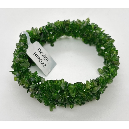 1030 - A 2.5cm wide elasticated bracelet made from multiple green spinel chips. New with tags.