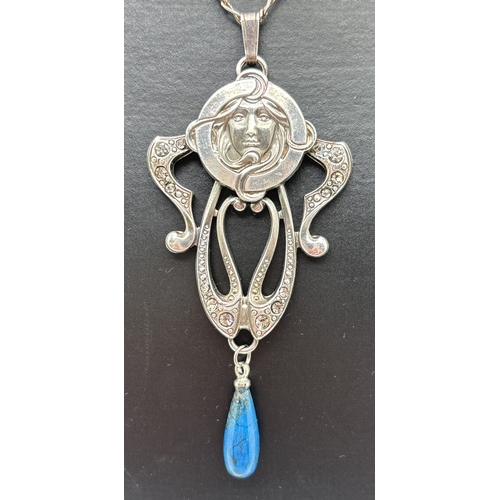 1031 - An Art Nouveau design white metal stone set pendant on a 16